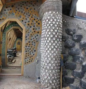 A barebones view of how tires, cans and bottles are used in building Earthship homes.