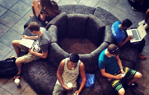Students sitting on circular couch studying