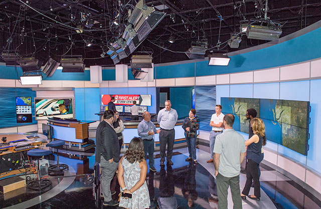 photo shows students and journalists in a TV studio