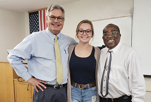 Photo of Henderson, FGCU student Hailey Countryman and Visiting Assistant Professor Peter Ndiangui.