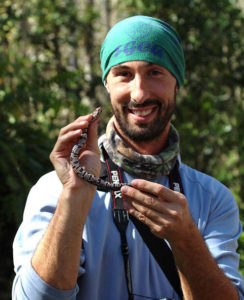 Photo shows professor holding snake