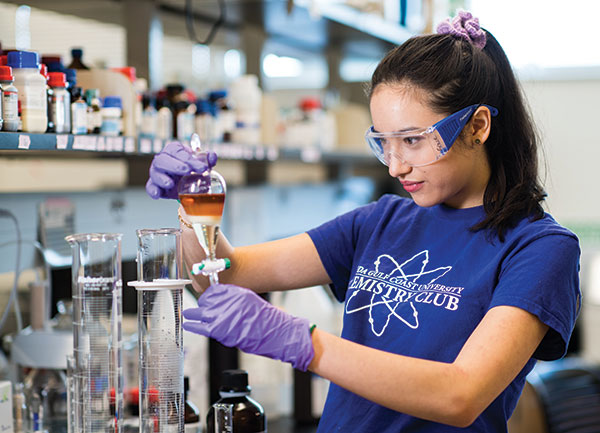 Student researcher Grace Anderson makes hand sanitizer in an FGCU chemistry lab.