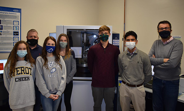 photo shows FGCU faculty with students in lab