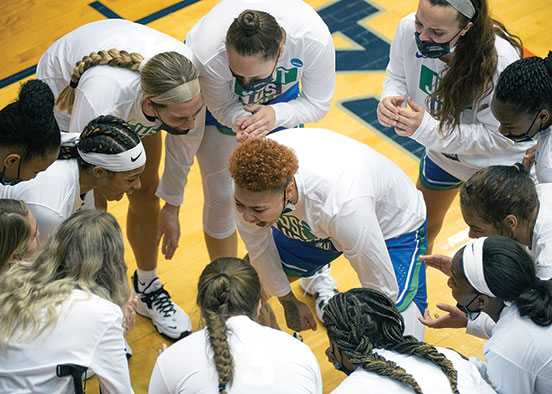 Kierstan Bell ( center) in huddle with team during a game against Michigan last year.