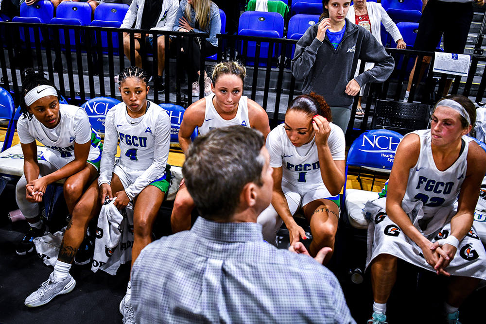 photo shows FGCU women's basketball coach with team