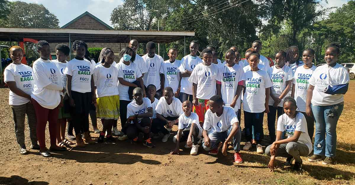 More than two dozen children in Nyeri, Kenya, wearing FGCU T-shirts