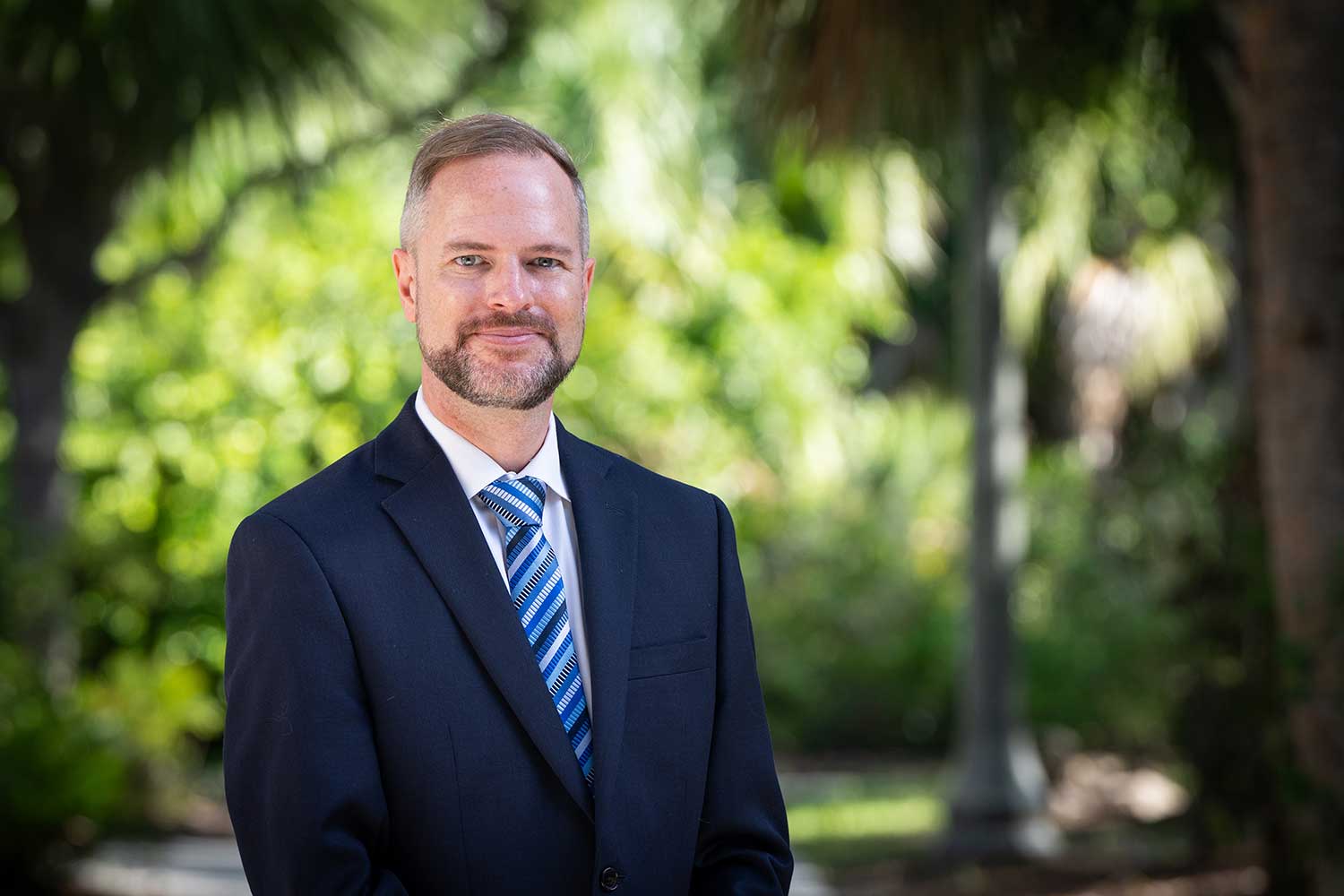 Tyler Fisher, dean of FGCU's Honors College, poses on campus