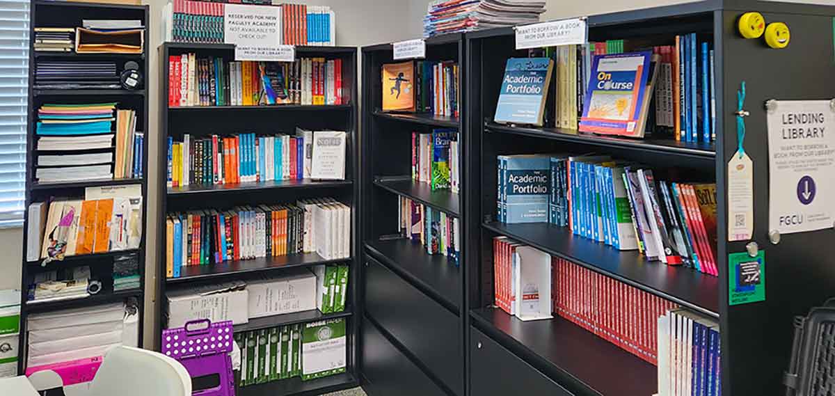 Three black, metal bookcases full of books