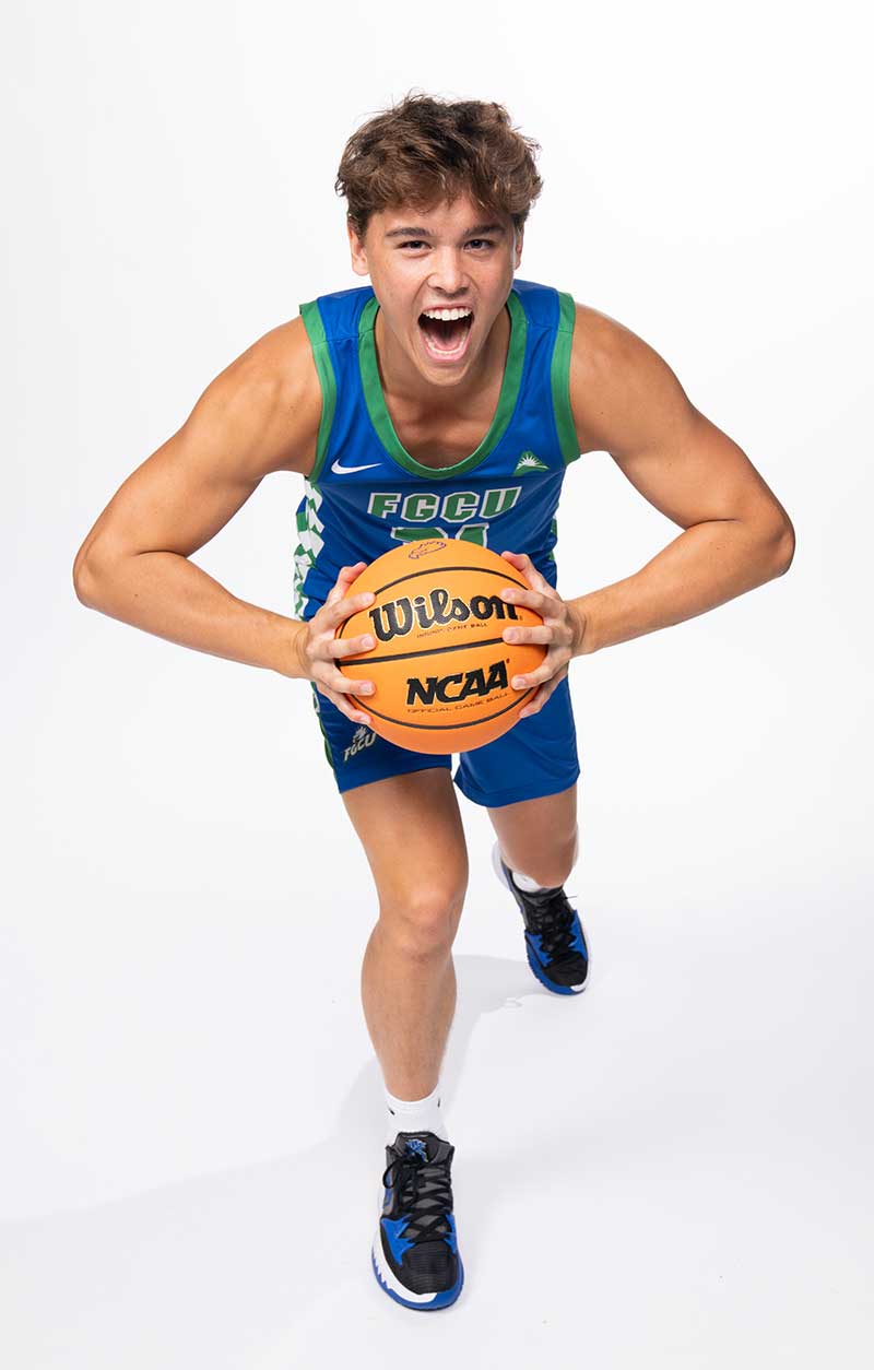 FGU basketball player Brandon Dwyer poses holding ball