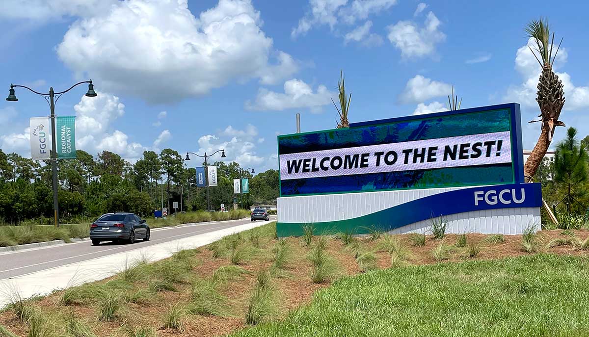 Photo shows a digital sign saying Welcome to the Nest on the FGCU campus.