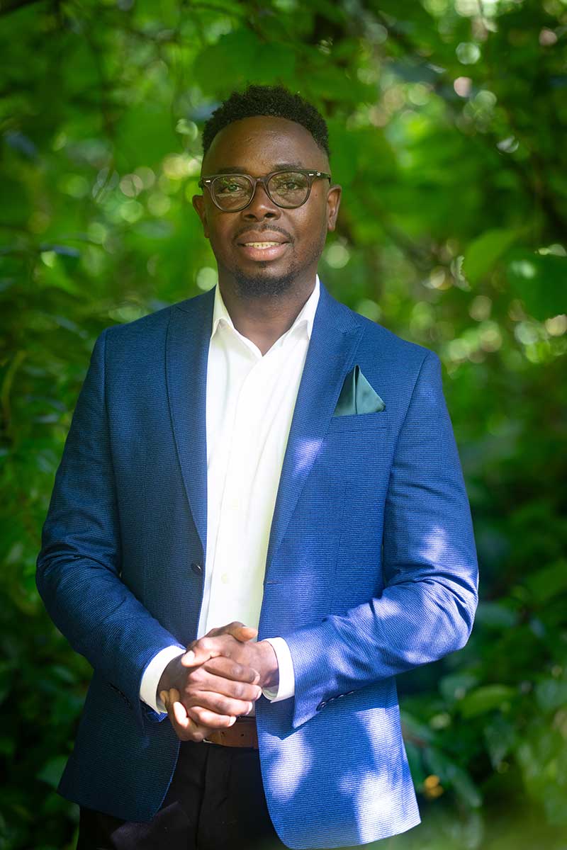 FGCU graduate Judes Sétalaire Albert standing in the Food Forest on campus