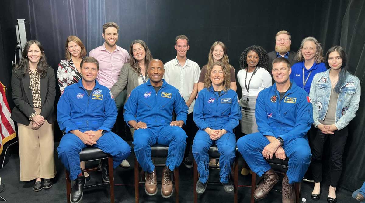 Communications staff pose with astronauts at Goddard Space Flight Center