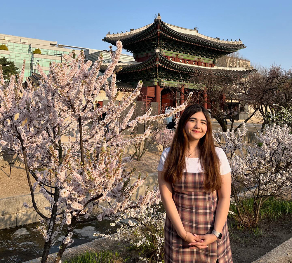 FGCU student standing in front of a pagoda in Korea