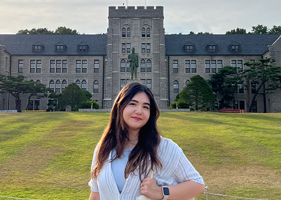 FGCU student standing in front of a campus in Korea