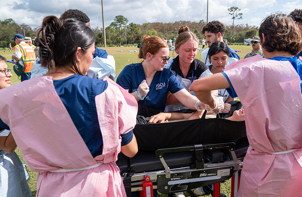 Students treat a fake patient during an emergency simulation