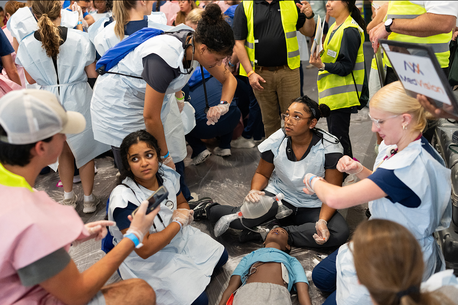 Students treat a fake patient during an emergency simulation