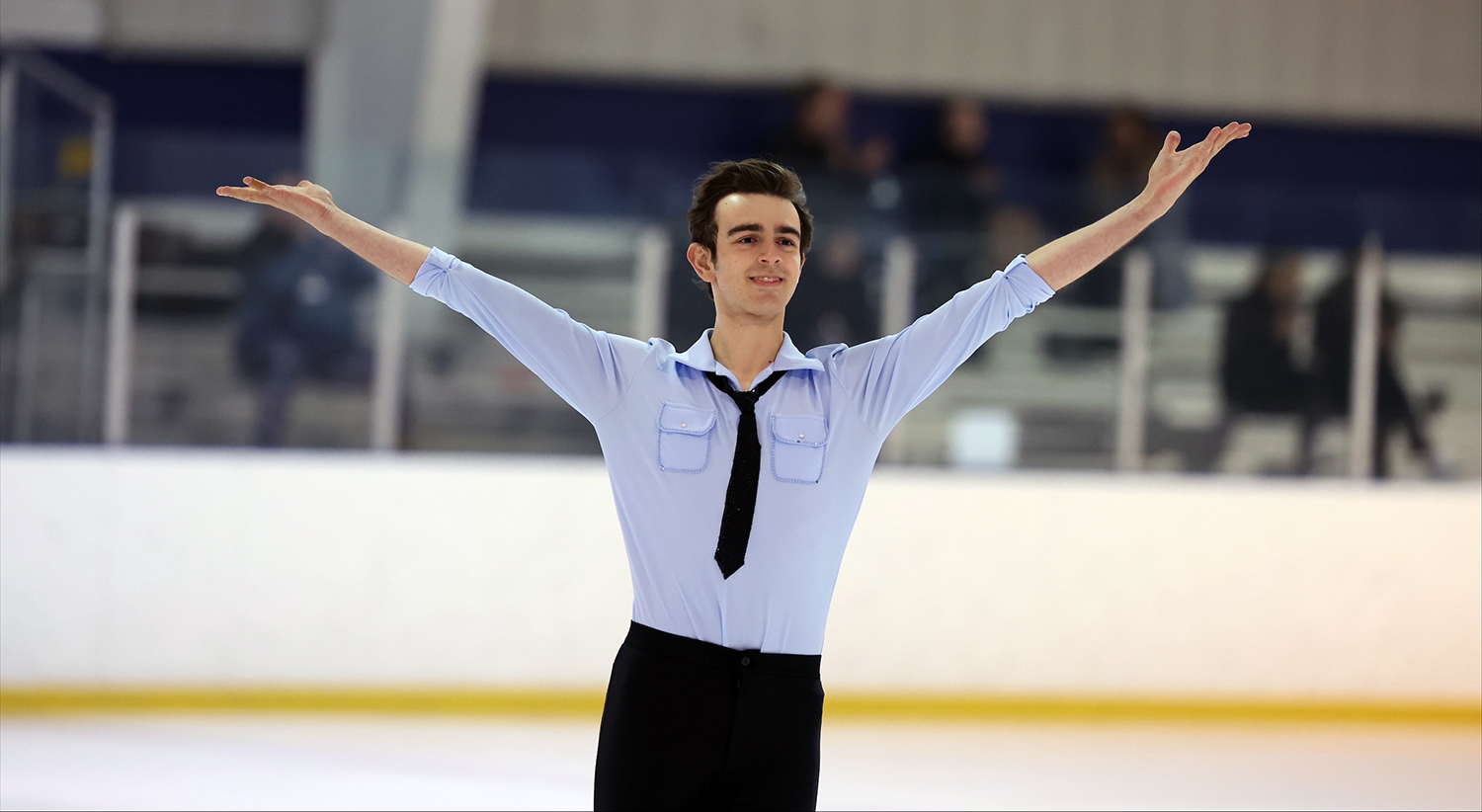 Man in blue shirt ice skating