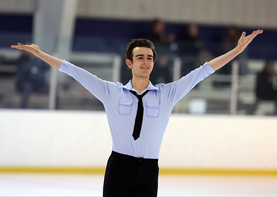 Man in blue shirt ice skating