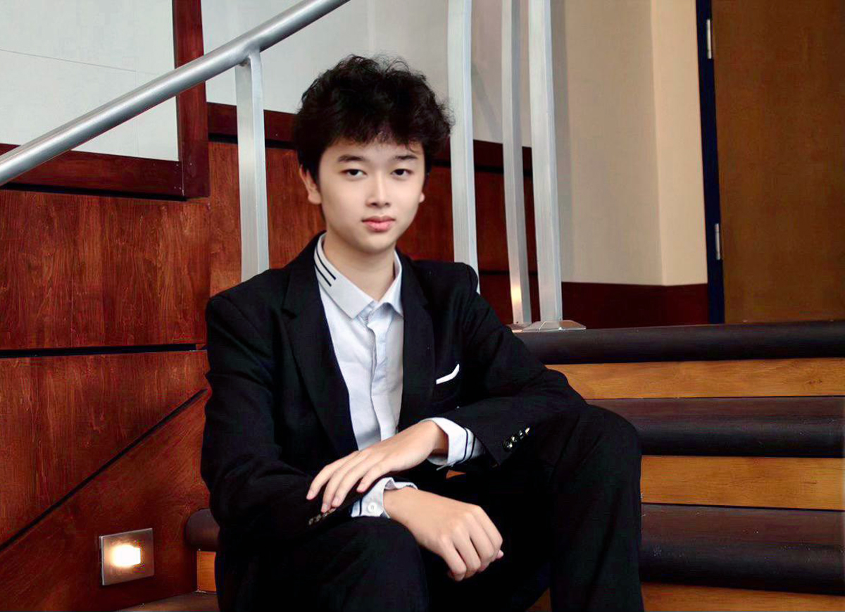 Man in black suit sitting on stairs