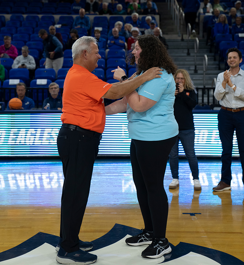 man and woman on basketball court