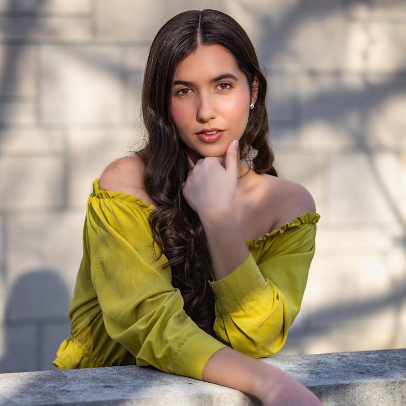 Woman in yellow top posing