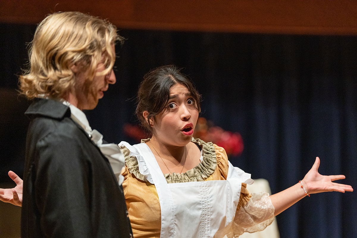 Woman in costume singing opera on stage