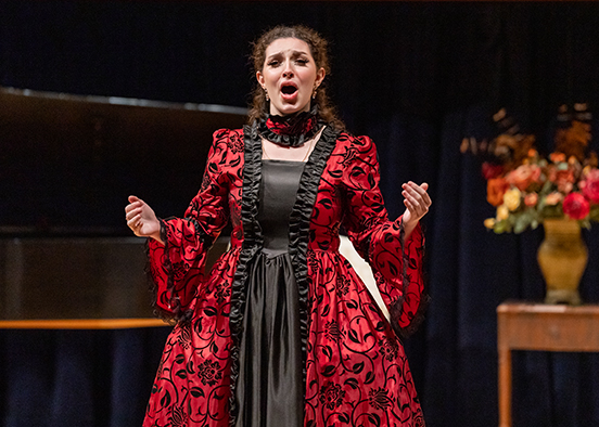 Woman in red dress singing on stage