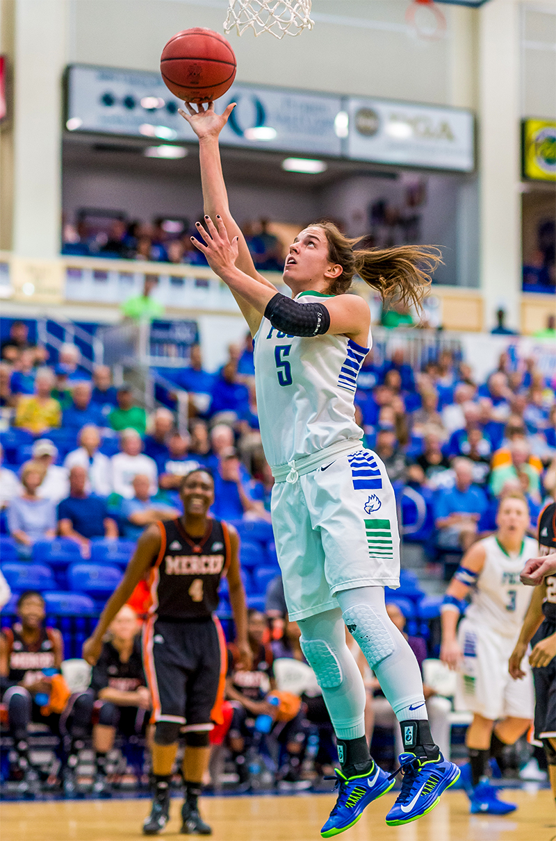 Female basketball player making a shot