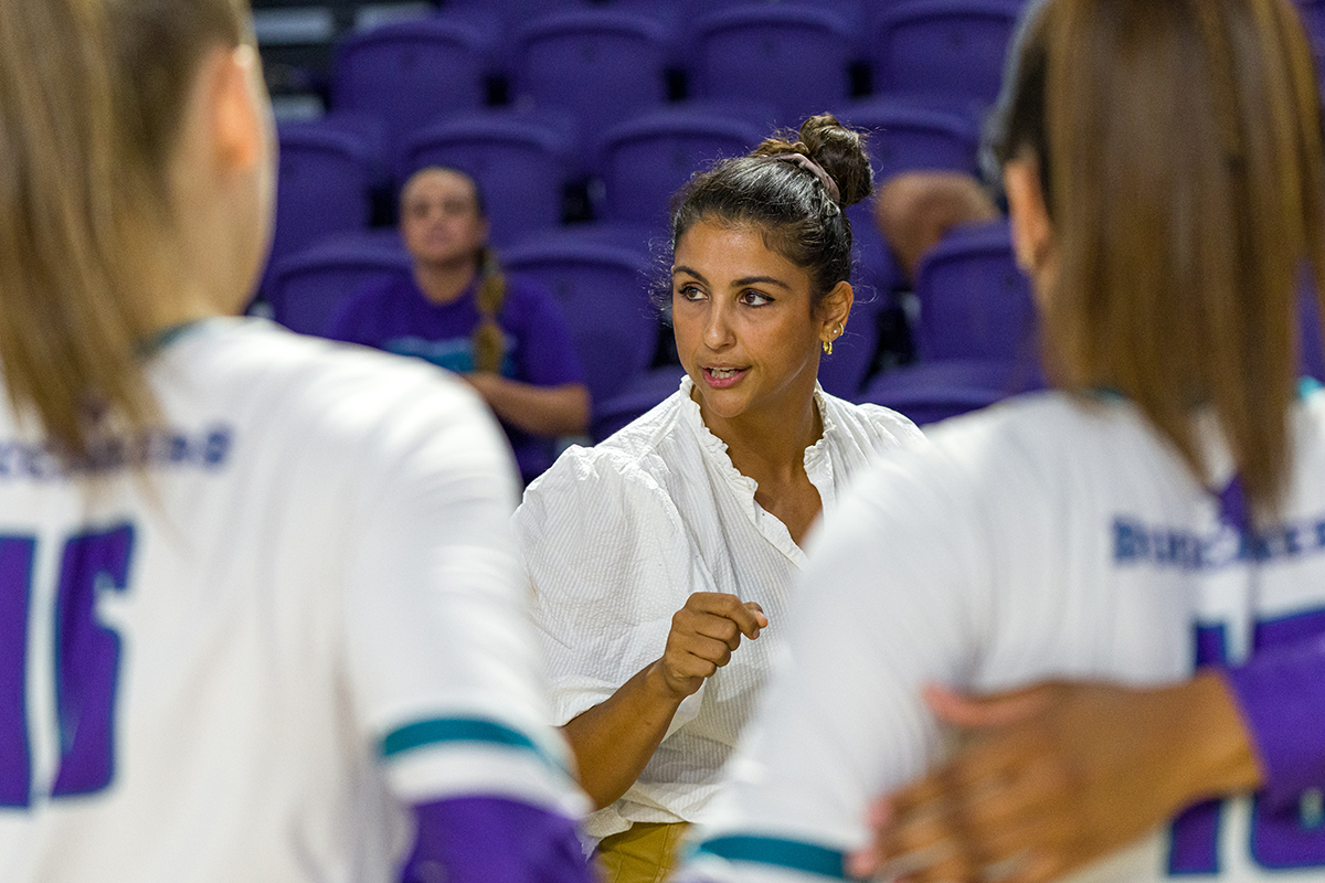 Woman white shirt coaching players