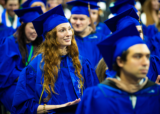 Woman in cap and gown at commencement ceremony