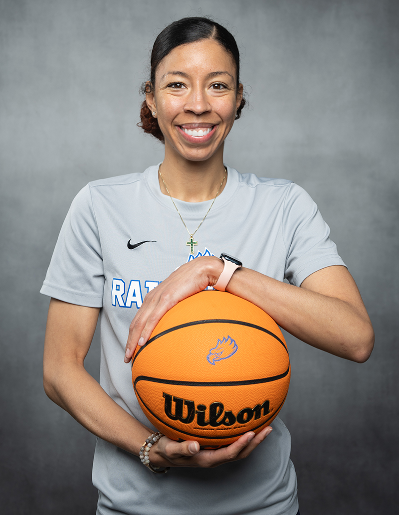 Woman holding basketball and smiling