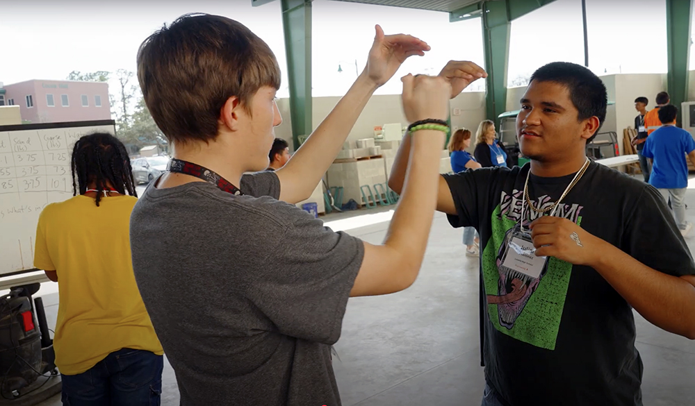 Two students in T-shirts talking