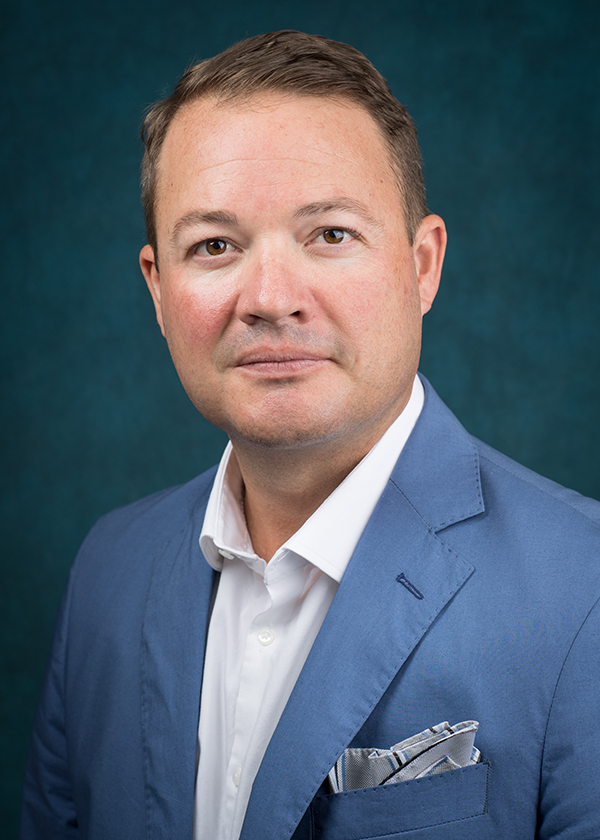 Man in blue suit and white shirt