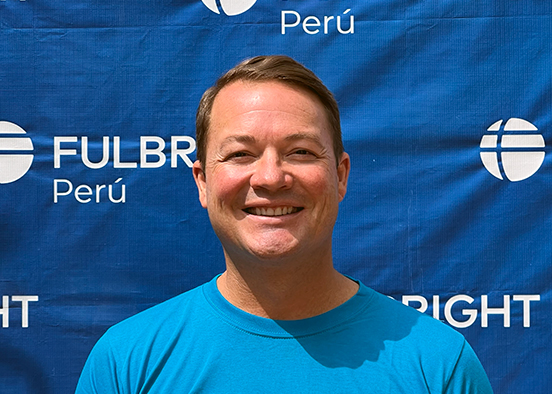 Man in blue T-shirt smiling