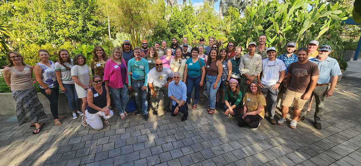 A panoramic photo of three dozen people outdoors