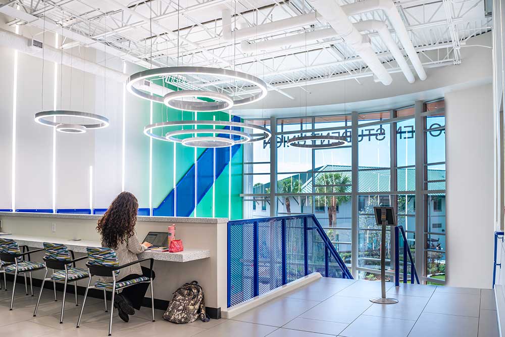 Interior of Cohen Student Union with study tables and circular lights.