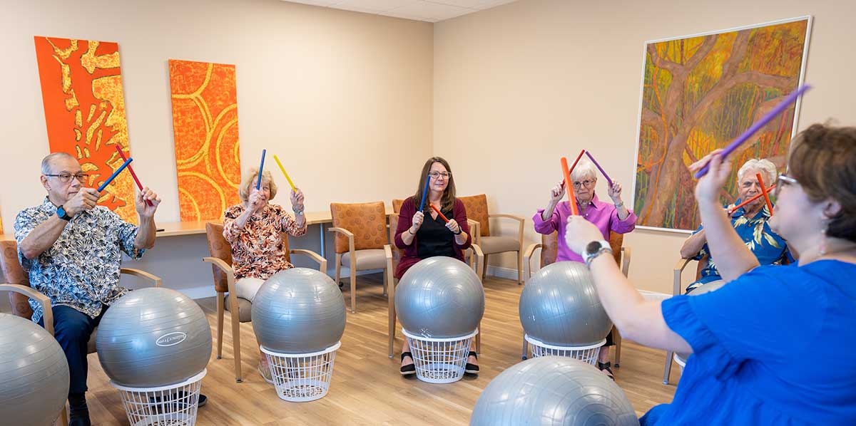 Group seated with exercise balls during guided music activity