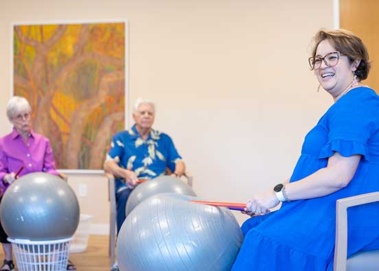 Group seated with exercise balls during guided music activity