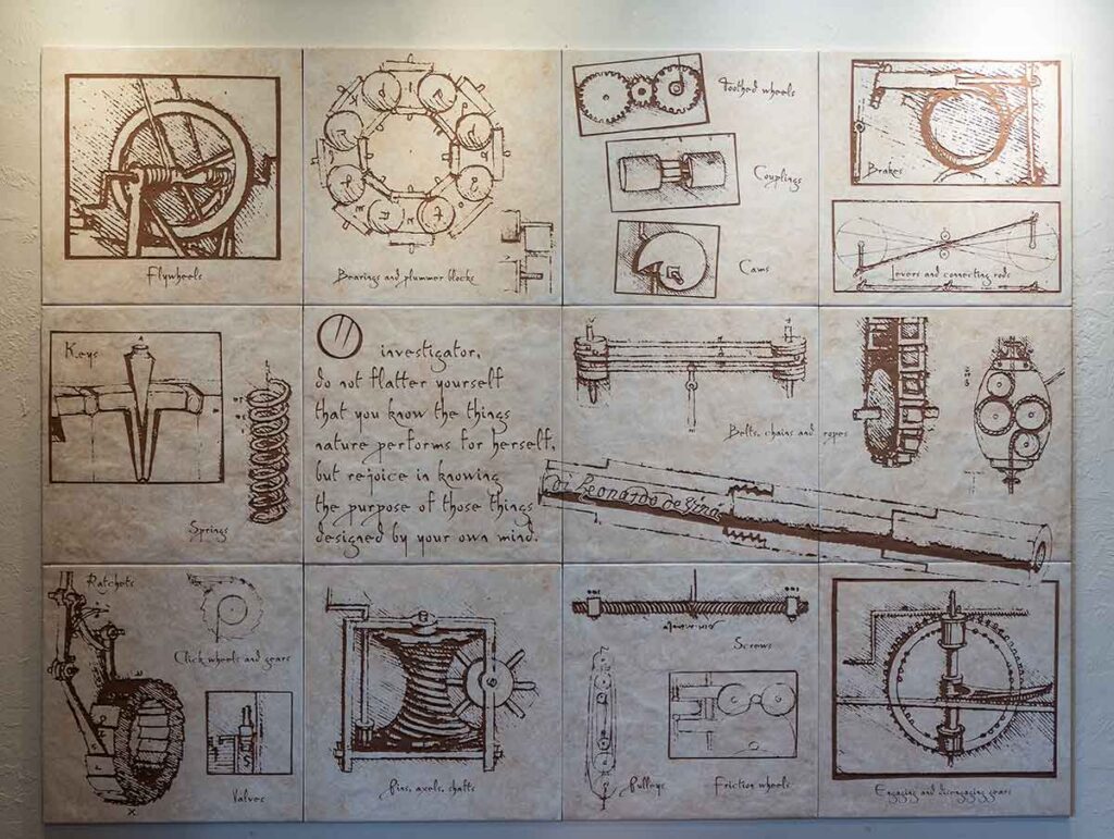 A photo of 12 etchings of various designs related to the inner workings of machines