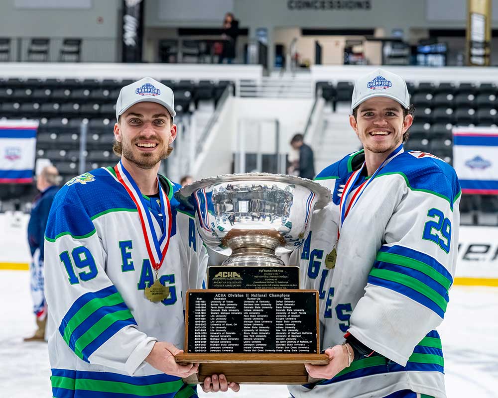 FGCU hockey players hold ACHA Division II national championship trophy on ice