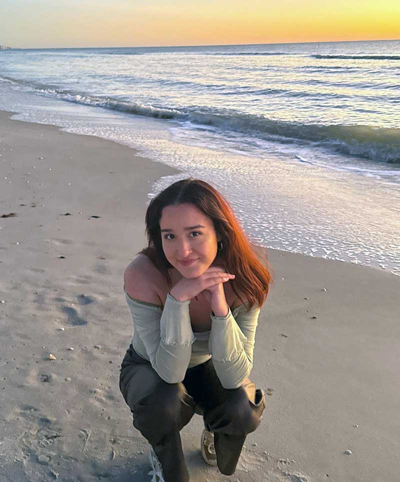 FGCU student on Florida beach at sunset during study abroad program