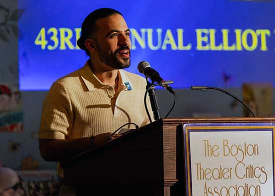 Speaker at podium at Boston Theater Critics Association awards event