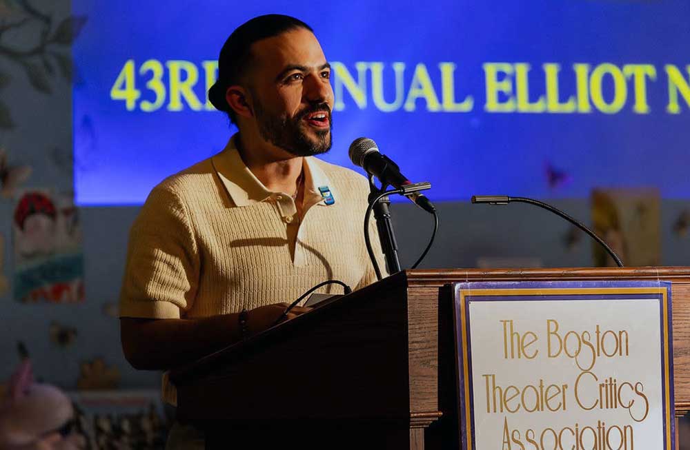 Speaker at podium at Boston Theater Critics Association awards event