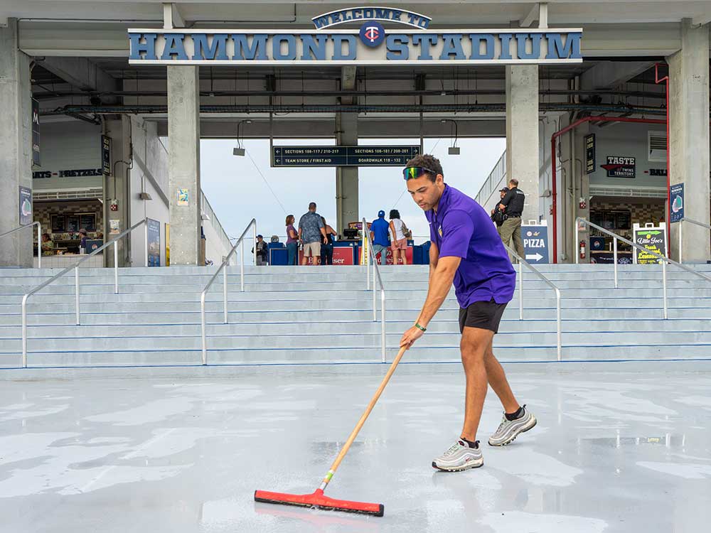 Mighty Mussels staff member cleans concourse at Hammond Stadium Fort Myers