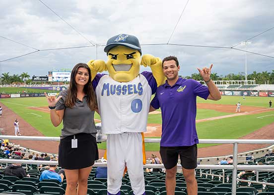 FGCU students with Mighty Mussels mascot at Hammond Stadium baseball game