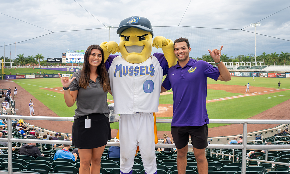 FGCU students with Mighty Mussels mascot at Hammond Stadium baseball game