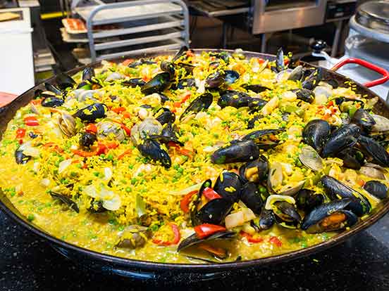 An oversized pan with seafood paella