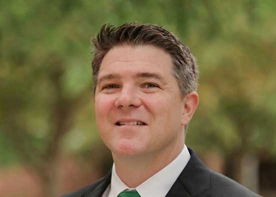 Man in suit photographed outdoors