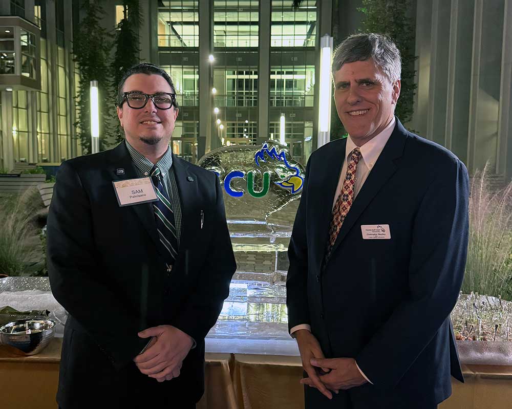 FGCU alumnus and faculty member at reception