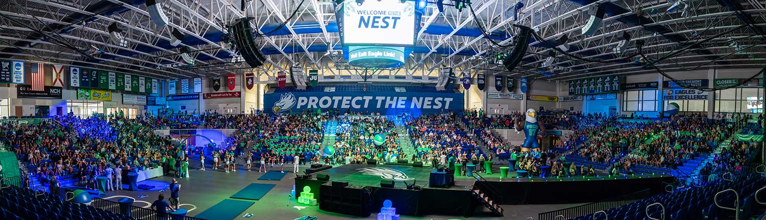 Panoramic view of FGCU welcome event at Alico Arena with students.